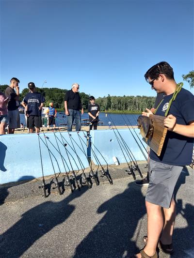 Volunteers from Massachusetts Wildlife Angler Education Program provide instruction on fishing to those who are new to the sport.